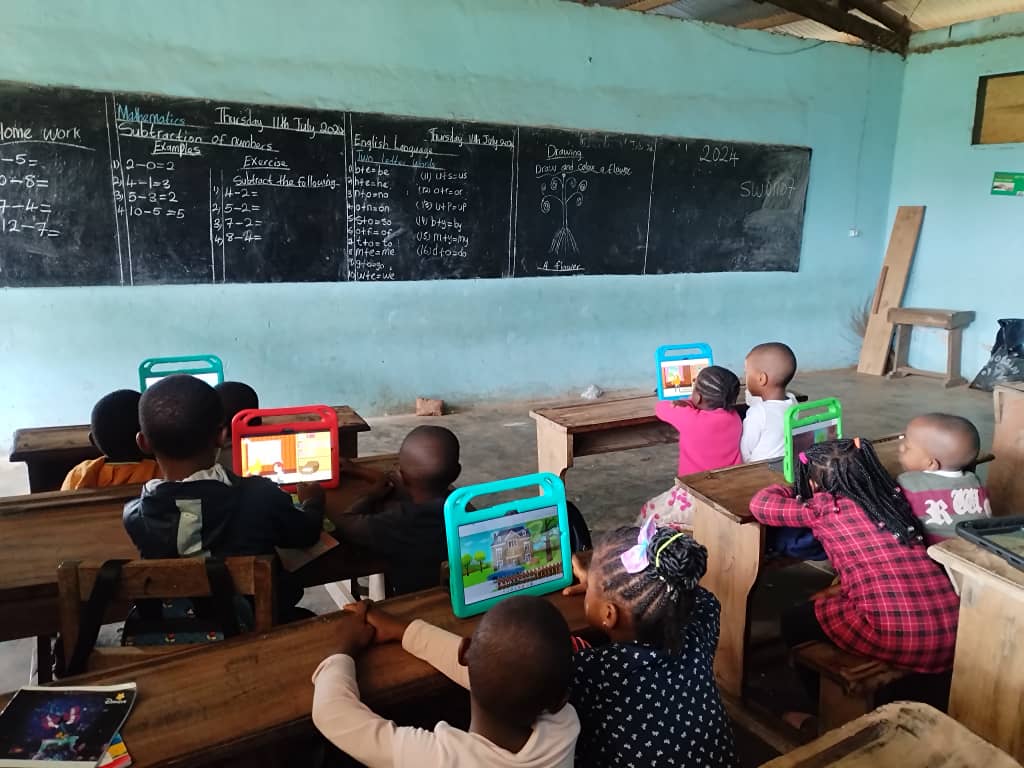 a group of children sitting at desks in a classroom